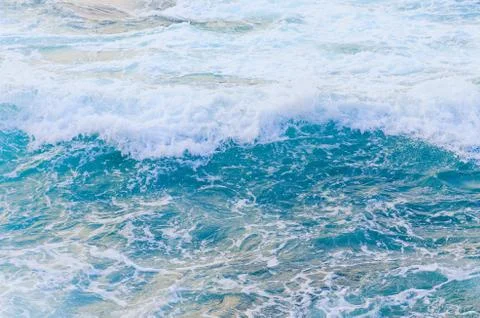 Top view sea texture. Foaming blue water surface. Sea water with foam. Stock Photos