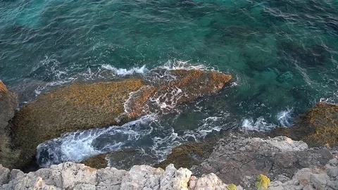 Top view of sea waves hitting rocks on the beach in Cyprus Stock Footage 85202673