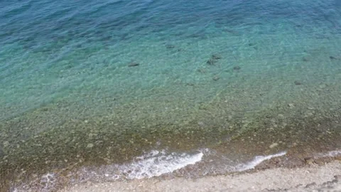 Top view of sea waves splashing on the beach Stock Footage 153612130