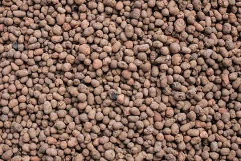 Top view on a seamless abstract background from expanded clay. Flat lay. Stock Photos
