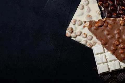 Top view in section on a bar of dark chocolate with hazelnuts Stock Photos