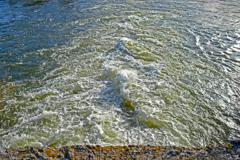 Top view of the seething stream below the dam on the river in the spring. Bac Stock Photos