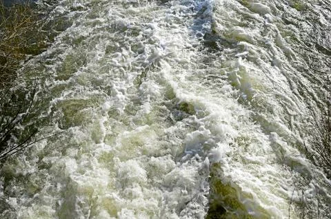 Top view of the seething stream below the dam on the river in the spring. Bac Stock Photos