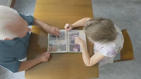 Top view of a Senior couple looking at an old photo album Video stock 92506366