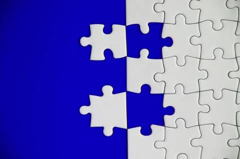 Top view of separated jigsaw puzzle on blue cover background. Copy spave 写真素材
