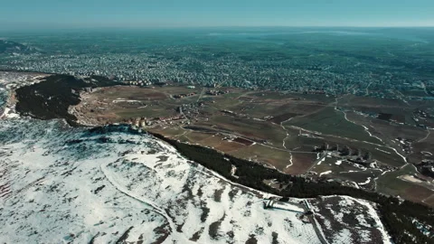 Top view of separation of snowy mountain and snowless city. climate change. Stock Footage 237611123