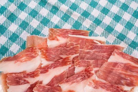 Top view of Serrano ham slices over plate and tablecloth Stock Photos