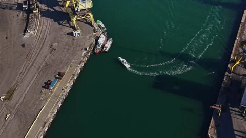 Top view of a service boat navigating between harbor piers Stock Footage 338185838