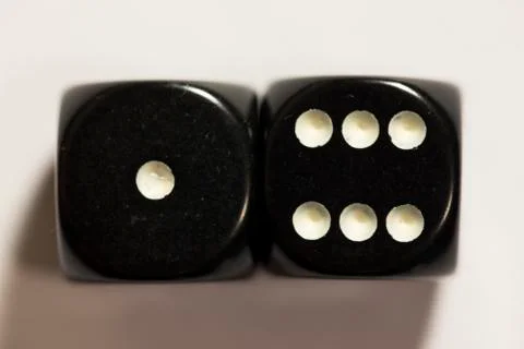 Top view of a set of black dice showing a seven Photos