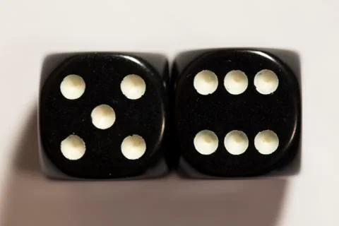 Top view of a set of black dice showing an eleven Photos