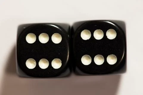 Top view of a set of black dice showing a twelve 스톡 사진