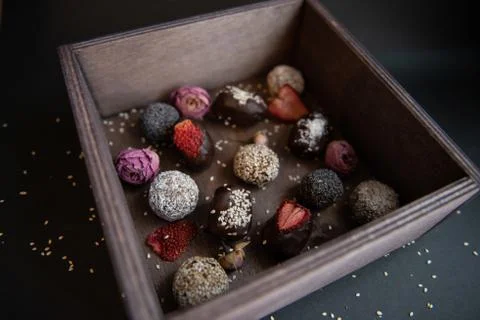 Top view of set handmade fruit and chocolate candies in a wooden box Stock Photos