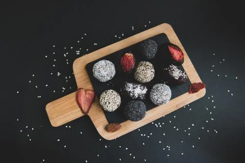 Top view of set handmade fruit and chocolate candies on a wooden board Stock Photos