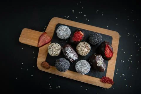 Top view of set handmade fruit and chocolate candies on a wooden board Stock Photos