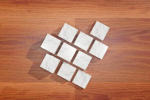 Top view of a set of marble cubes, cutouts used for product display on a wooden Stock Photos