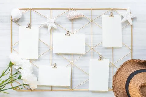 Top view set of note pad clip frame and summer hat with flower on white wood  Stock Photos