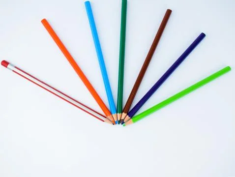Top view of seven different colored pencils arranged in a half circle pattern 스톡 사진