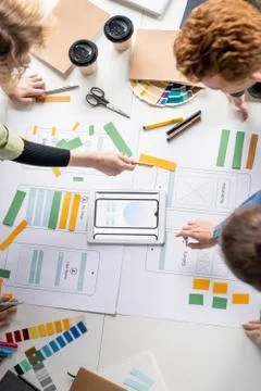 Top view of several creative professional developers discussing sketches Stock Photos