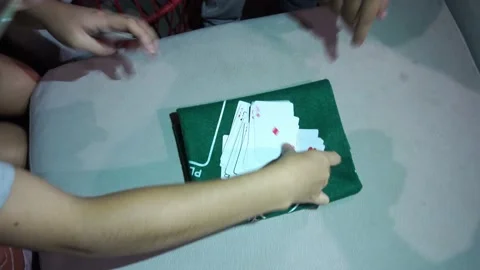 Top view of several friends playing cards with their hands in 4k Stock Footage 199511816