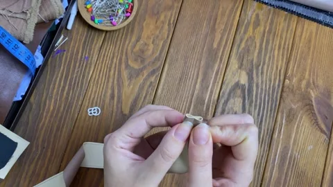 Top view of the sewing process on a wooden table. Video stock 293233421