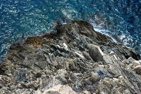 Top view of the sharp rocks. mountain meets sea Stock Photos