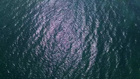 Top view of shimmering sea surface with rippling waves and sun reflections Stock-Footage 308170353