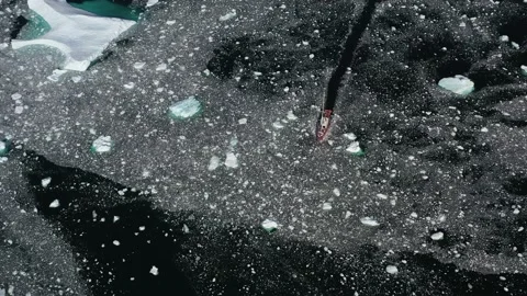 Top view of ship floating among small pieces of in Antarctica, drone footage. Stock Footage 231671710