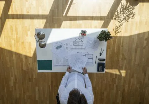 Top view shot of an architect checking documents with floating sun Stock Photos