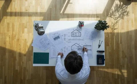 Top view shot of an architect checking documents with floating sun Stock Photos