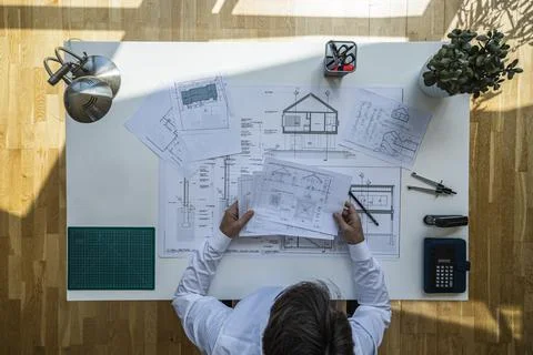 Top view shot of an architect checking documents with floating sun Stock Photos