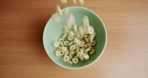 Top View Shot Breakfast Cereal Falling into Bowl Zoom In Stock Footage 128103226