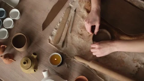 Top view shot of ceramic artist sculpting ceramic bowl by her hands Stock Footage 236372841