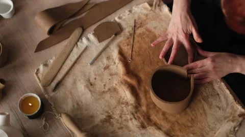 Top view shot of ceramic artist sculpting ceramic bowl by her hands Stock Footage 236373543