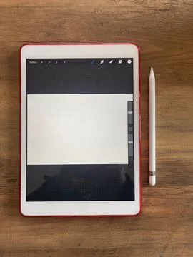 Top view shot of a digital tablet and stylus pen on wooden desk Stock Photos