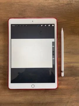 Top view shot of a digital tablet and stylus pen on wooden desk Stock Photos