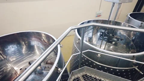 Top view shot of empty metal barrels on winemaking factory, clean equipment for Stock Footage 296758050