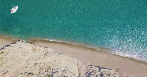 Top view shot flying over the coast of Greece sandy beach  Stock Footage 77829399