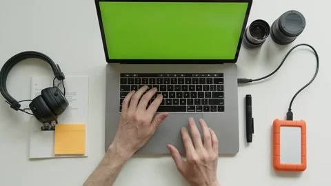 Top View Shot Of Green Screen Laptop, Smartphone And headphones, hdd disc On A Stock Footage 243645829