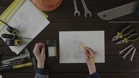 Top view shot. A guy checking data for the schematics Stock Footage 80020777