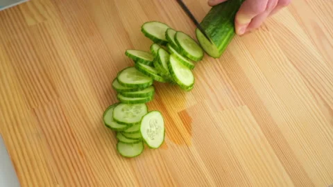 Top view shot of man cutting green cucumber Stockbeeldmateriaal 171911305