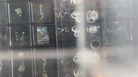 Top view shot motion sliding revealing rows of earrings piercing jewelry box Stock Footage 278349466