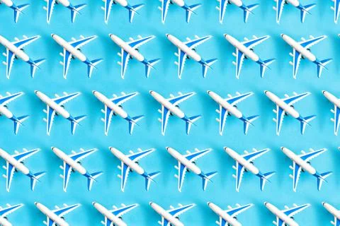 Top view shot of pattern small toy planes on the blue background Stock Photos