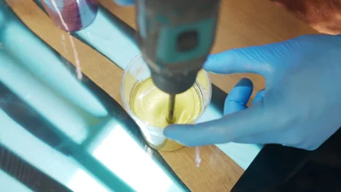 Top view shot of plastic cup with yellow substance on amazing individual wooden Video stock 262985140