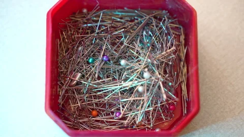 Top view shot of red plastic box with metal straight pins for sewing, tailor Stock-Footage 252427980