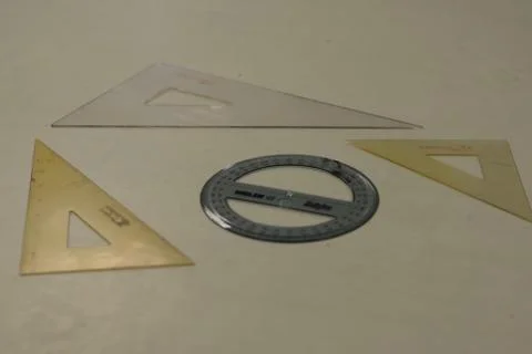 Top view shot of triangular and round rulers  lying on the table 스톡 사진