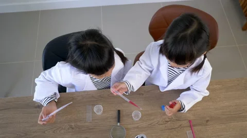 Top view shot, Two Asian siblings wearing coat and clear glasses are using Stockbeeldmateriaal 172183499