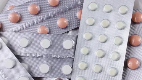 Top view of silver foil blister packs with medical pills circle rotation Stock Footage 233444069