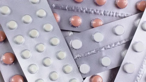 Top view of silver foil blister packs with medical pills circle rotation Video stock 234780937