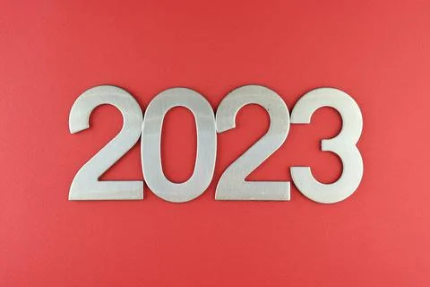 Top view silver numerals with the new year on a red monochrome background Stock Photos