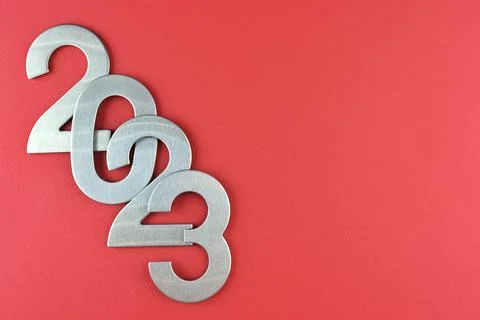 Top view silver numerals with the new year on a red monochrome background Stock Photos